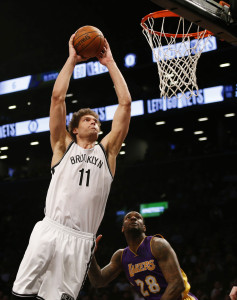 Mar 29, 2015; Brooklyn, NY, USA;  Brooklyn Nets center Brook Lopez (11) goes to the basket against Los Angeles Lakers center Jordan Hill (27) and forward Tarik Black (28) during the second half at Barclays Center. The Brooklyn Nets won 107-99.  Mandatory Credit: Noah K. Murray-USA TODAY Sports