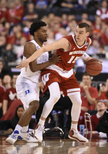 Apr 6, 2015; Indianapolis, IN, USA; Wisconsin Badgers forward Sam Dekker (15) dribbles in the low post defended by Duke Blue Devils forward Justise Winslow (12) during the second half in the 2015 NCAA Men's Division I Championship game at Lucas Oil Stadium. Mandatory Credit: Robert Deutsch-USA TODAY Sports